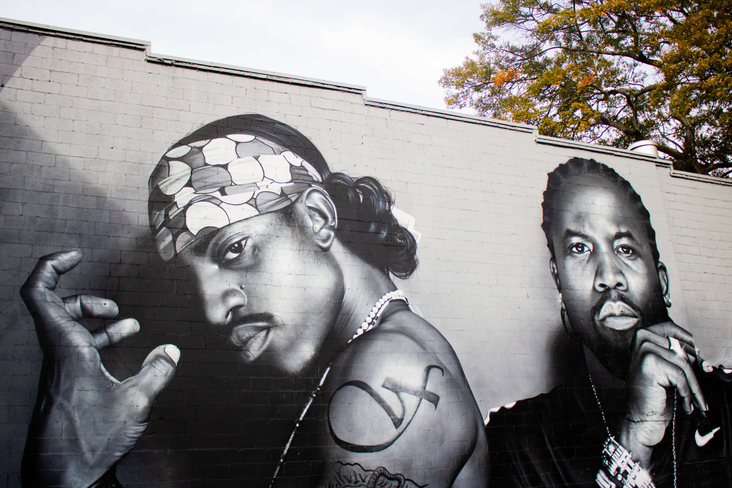 A black and white mural of two men.