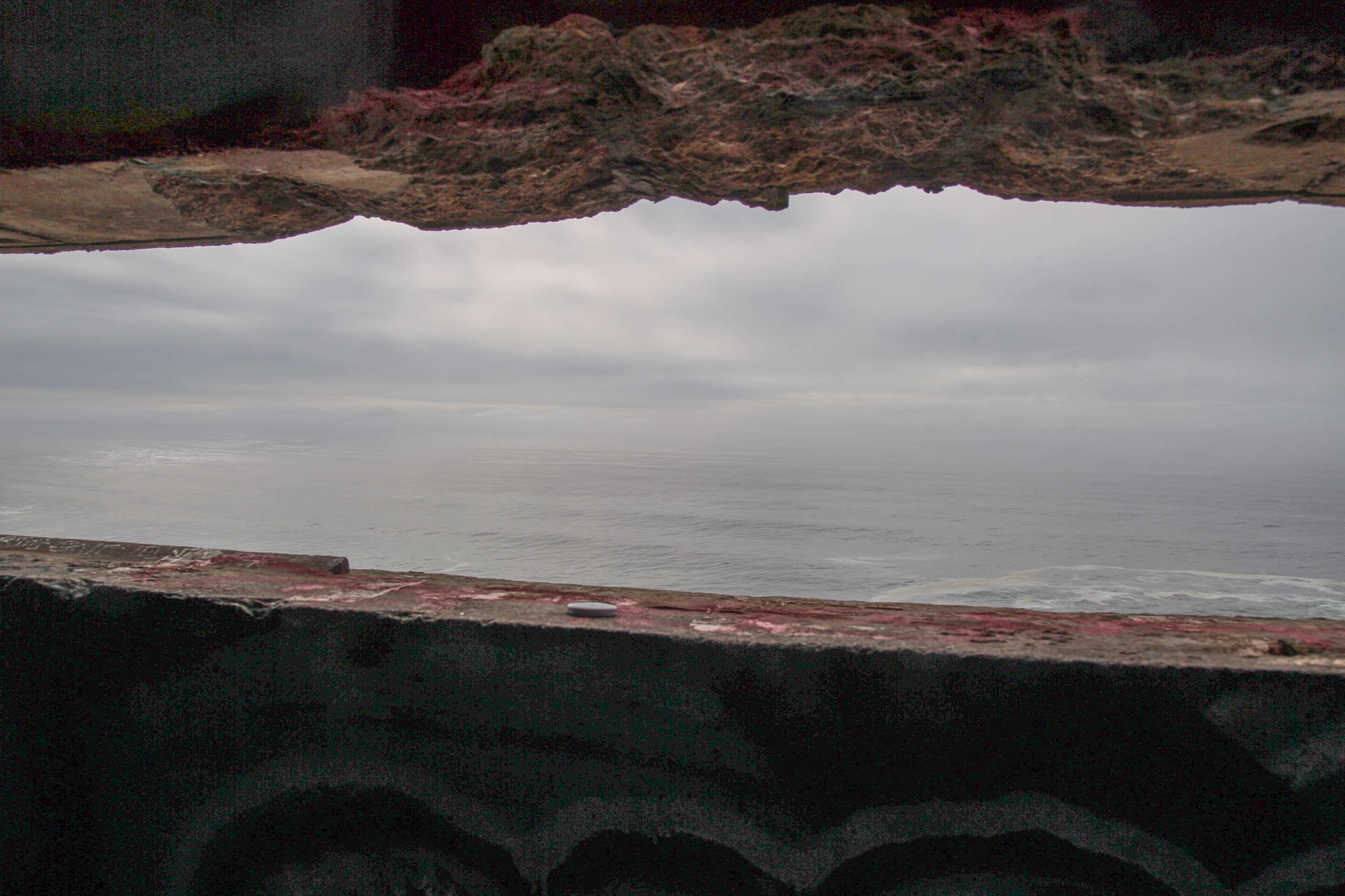 Gray sky seen from cement cave.